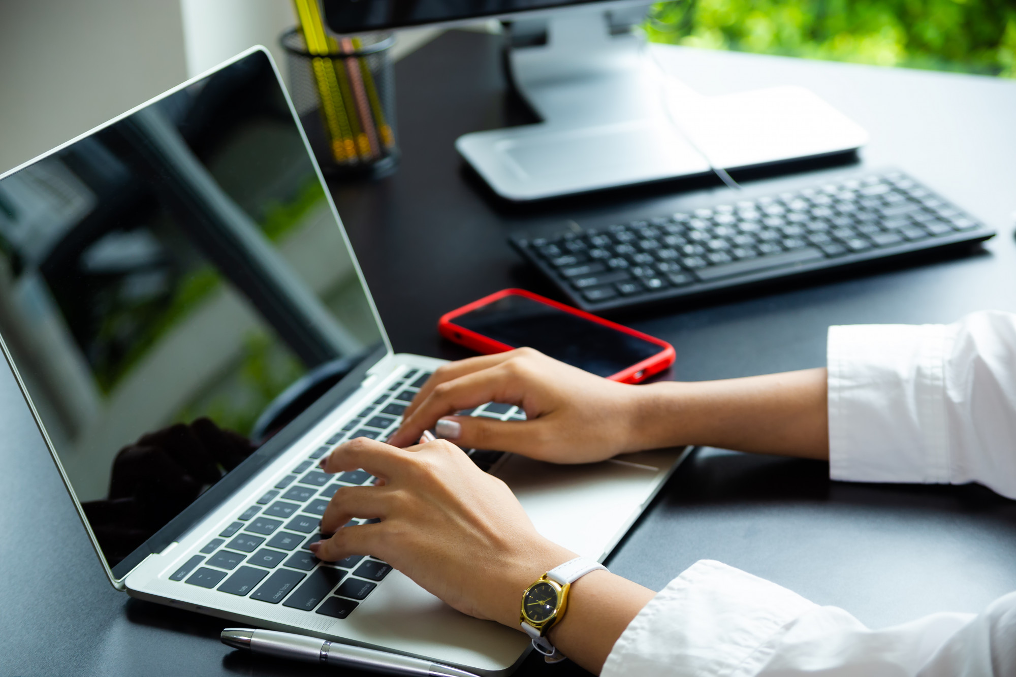 female-hand-typing-keyboard-laptop